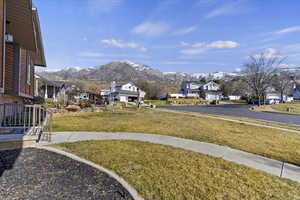 View of green lawn with a mountain view and a residential view