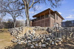View of property exterior with a deck and brick siding