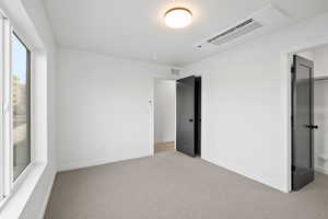 Photo of finished unit- Photo of finished unit - Unfurnished bedroom with carpet flooring and cooling unit