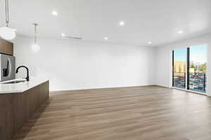 Photo of finished unit - Unfurnished living room with recessed lighting and light wood-style floors