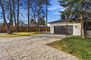Garage featuring decorative driveway
