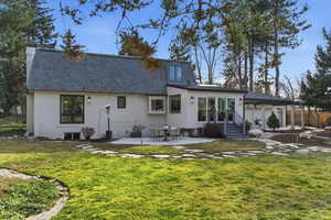 Rear view of property featuring a patio and a high end roof