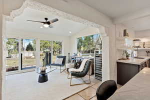 Sitting room with lofted ceiling with beams, a ceiling fan, and recessed lighting