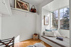 Sitting room with light wood-type flooring and baseboards