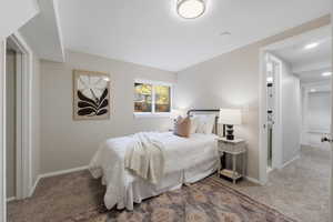 Bedroom featuring carpet and baseboards