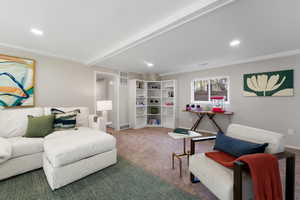 Living room featuring carpet floors, recessed lighting, crown molding, and beamed ceiling