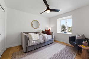 Bedroom featuring hardwood / wood-style flooring, a closet, and a ceiling fan