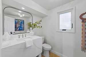 Half bathroom with vanity and recessed lighting