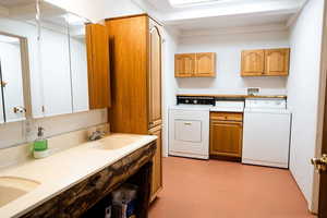 Laundry area featuring cabinet space, washer and dryer, and concrete flooring