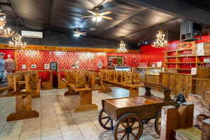 Miscellaneous room featuring ceiling fan and suspended lighting