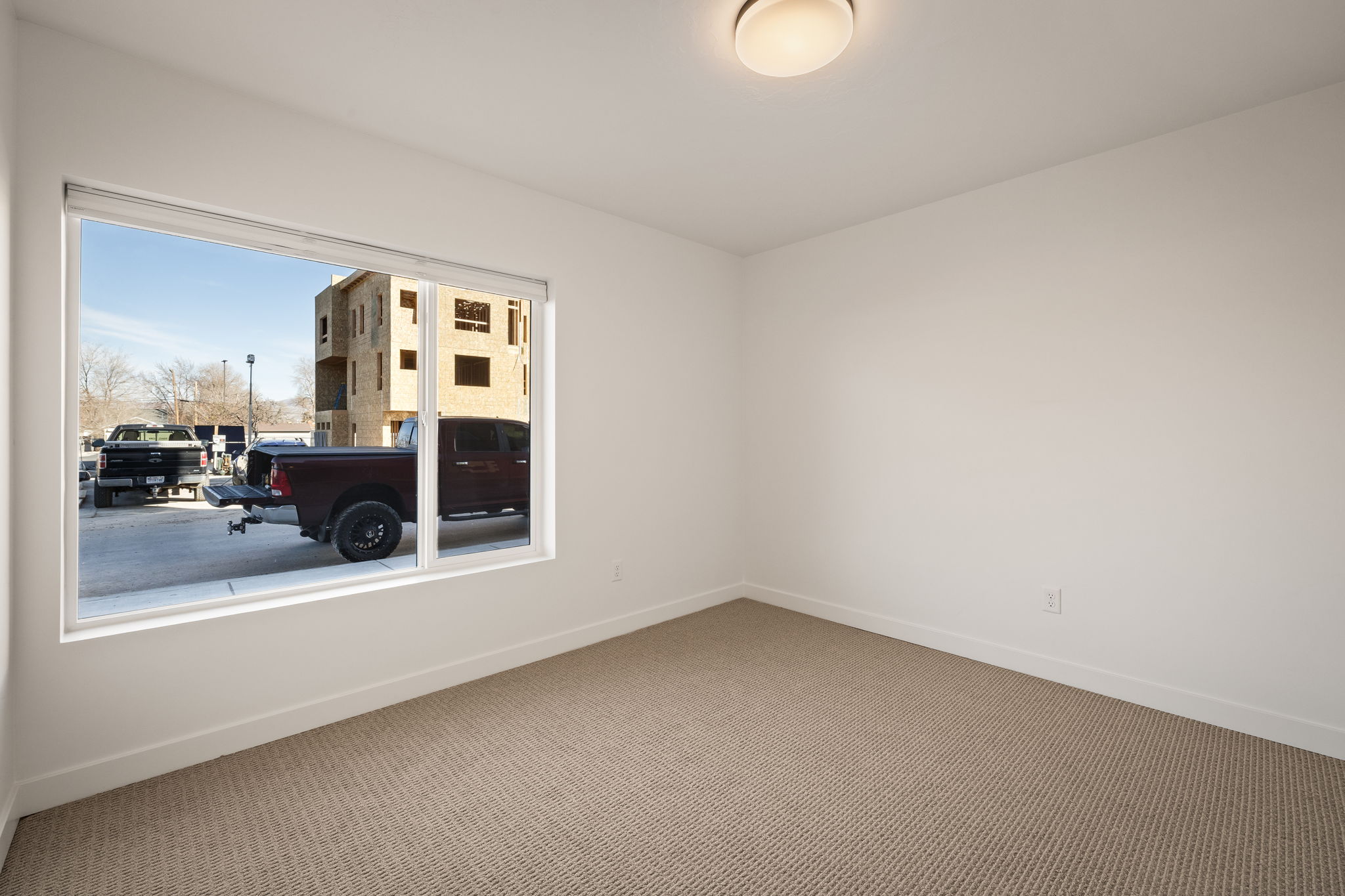 Spare room featuring carpet and baseboards