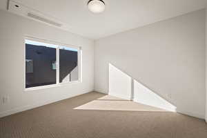 Carpeted empty room with baseboards