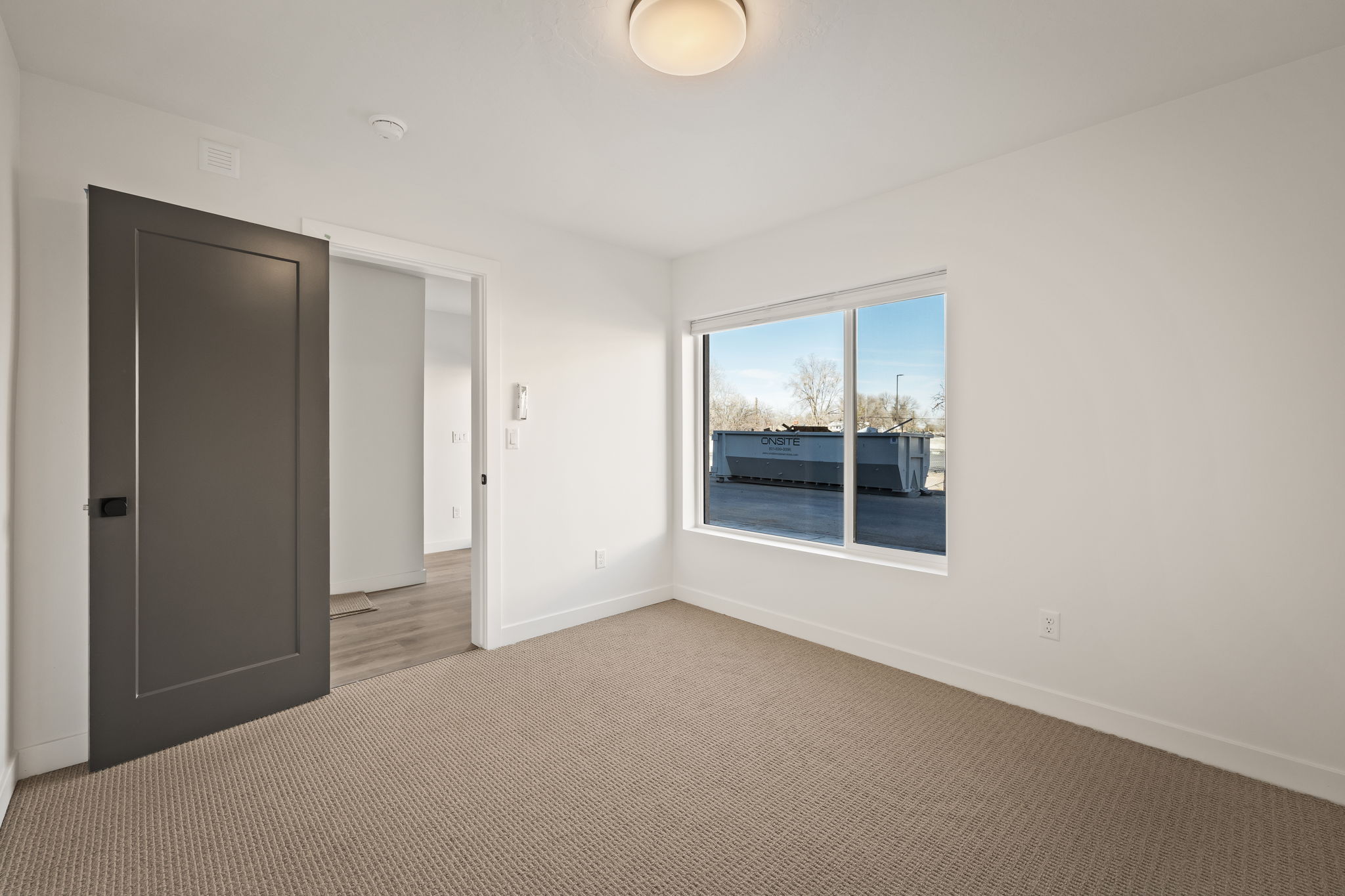 Unfurnished bedroom featuring carpet floors and baseboards