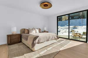 Bedroom featuring light wood finished floors and access to outside
