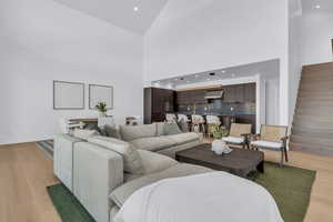 Living area featuring light wood-type flooring, recessed lighting, and vaulted ceiling