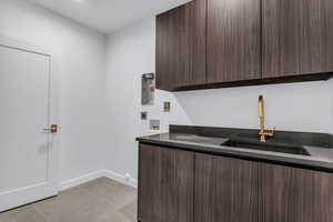 Laundry room with washer hookup, light tile patterned floors, and electric dryer hookup
