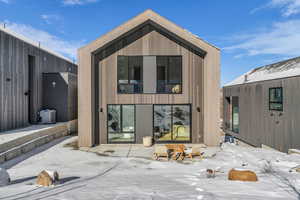 Snow covered house with a patio