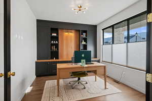 Home office featuring wood finished floors and baseboards