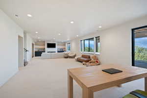 Dining space featuring recessed lighting and light carpet