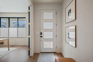 Entryway with wood finished floors and baseboards