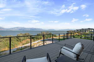 Wooden deck featuring a water and mountain view