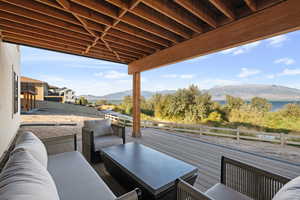 View of patio with an outdoor living space and a deck with mountain view