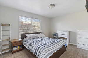 Carpeted bedroom featuring baseboards