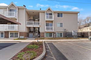 View of complex with uncovered parking