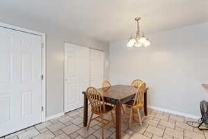 Dining area featuring hanging lights and baseboards