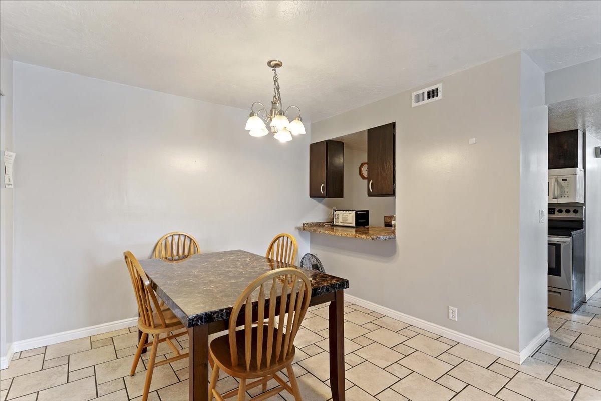 Dining area featuring suspended lighting and baseboards