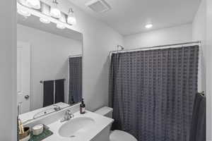 Bathroom with vanity and a shower with shower curtain