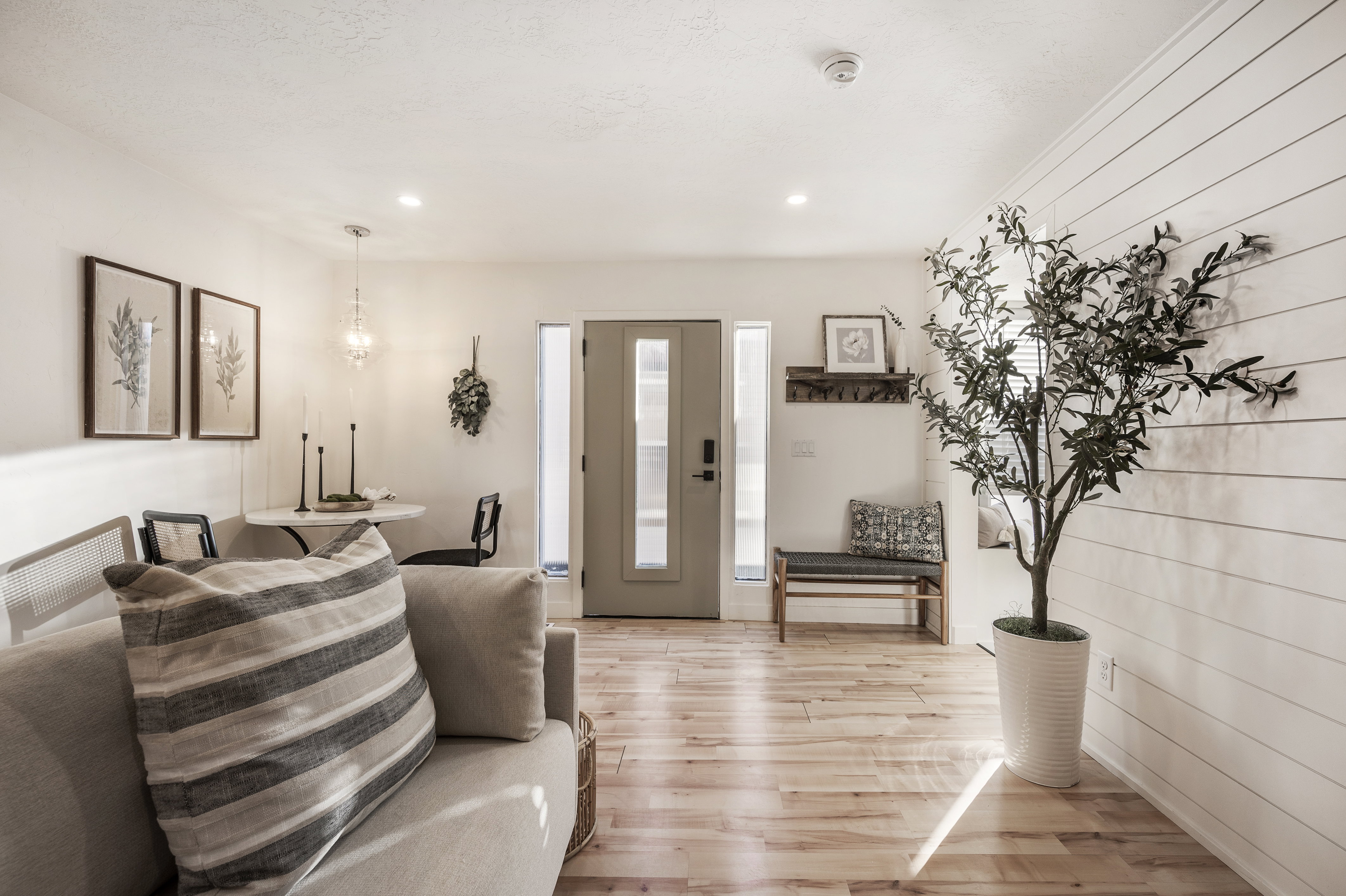 Living room with light wood finished floors and recessed lighting