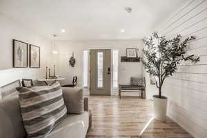 Living room with light wood finished floors and recessed lighting