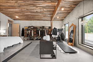 Bedroom with concrete flooring, recessed lighting, and wooden ceiling