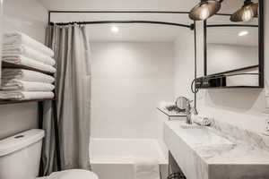 Full bathroom with shower / bath combo and vanity