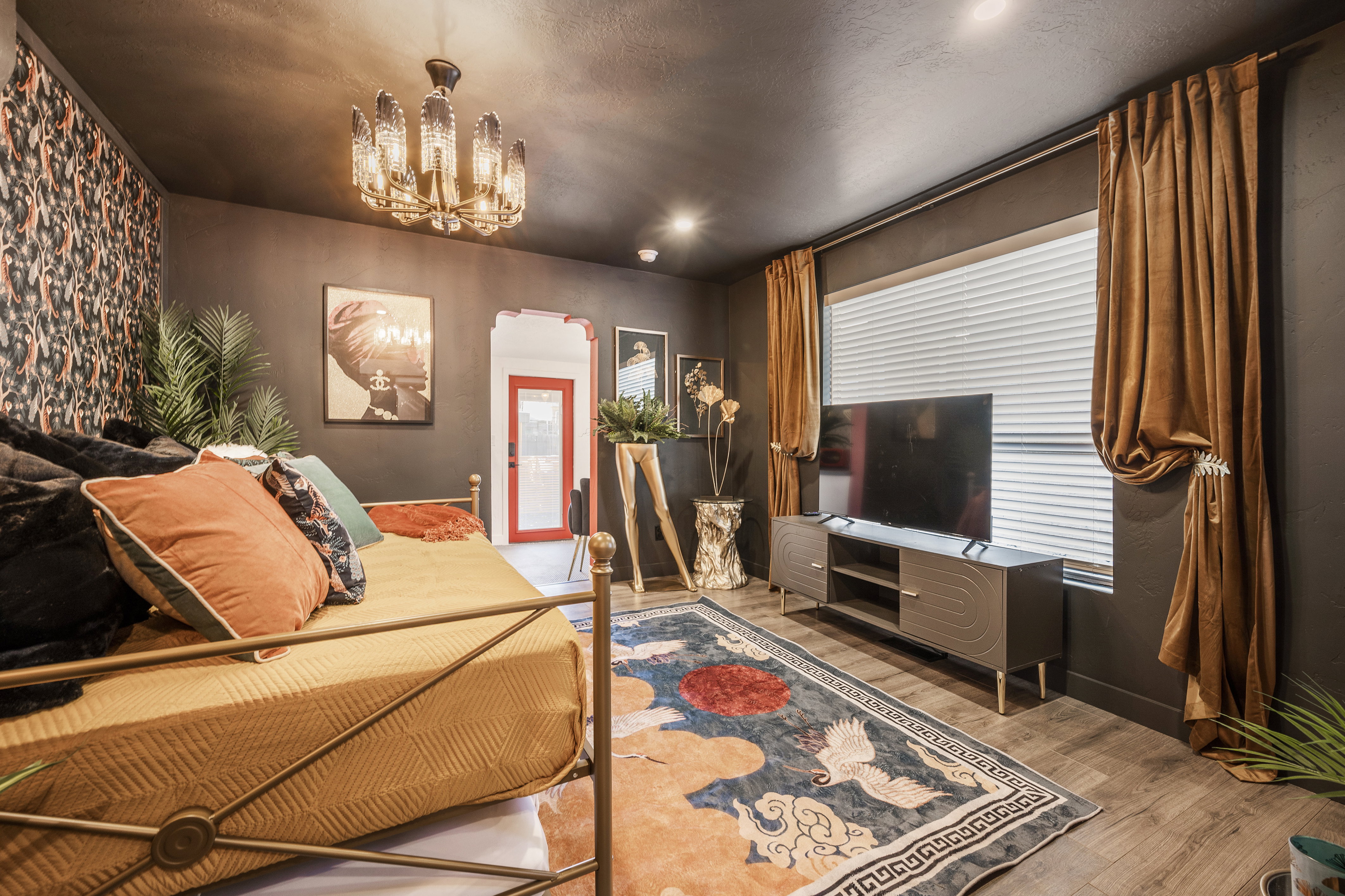 Bedroom with arched walkways, light wood finished floors, and a chandelier