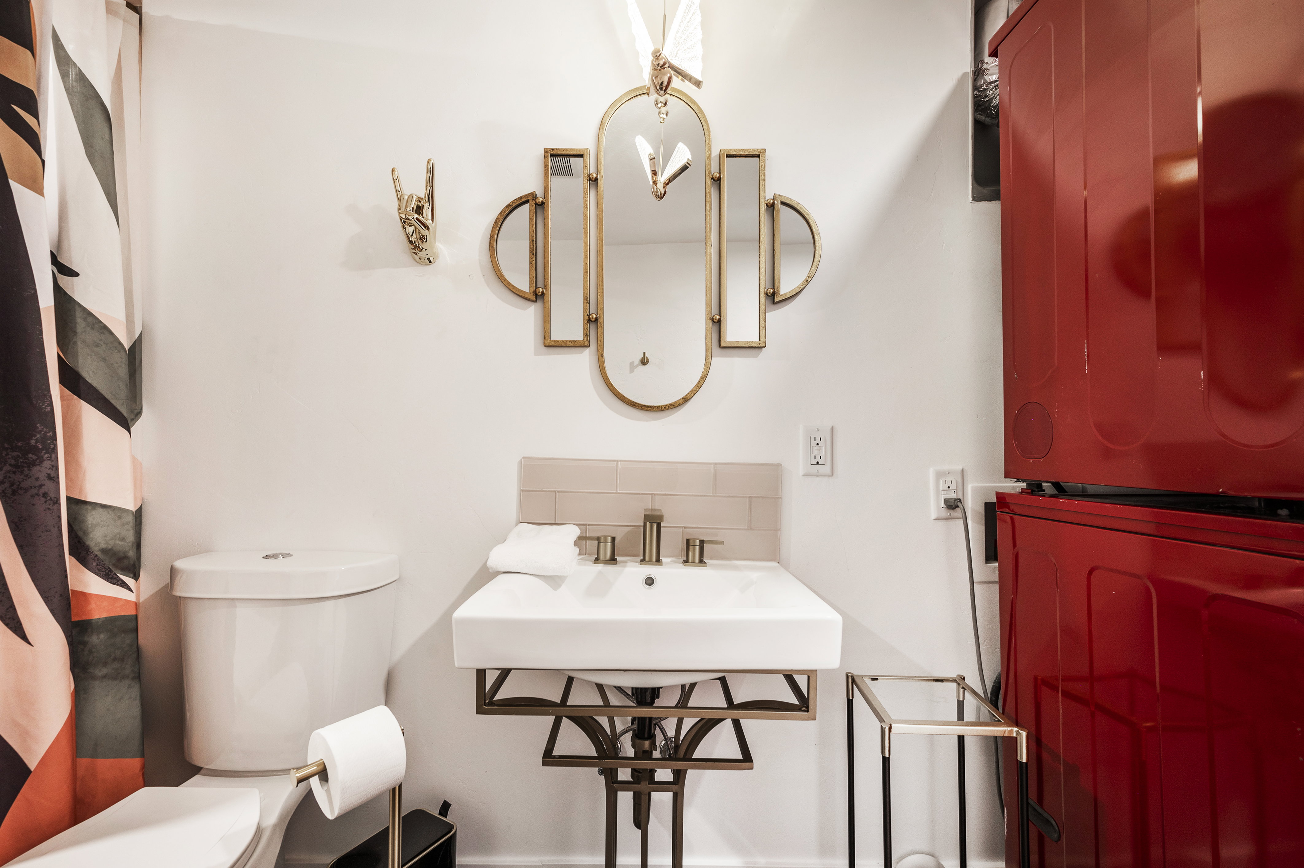 Bathroom featuring stacked washer / drying machine and decorative backsplash
