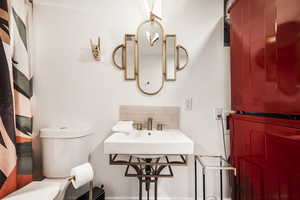 Bathroom featuring stacked washer / drying machine and decorative backsplash