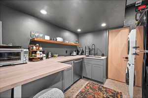 Bar with gray cabinetry, recessed lighting, dishwasher, butcher block countertops, and concrete flooring