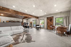 Living room with concrete flooring and recessed lighting