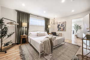 Bedroom with light wood finished floors and recessed lighting