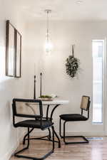 Dining room with light wood finished floors and baseboards