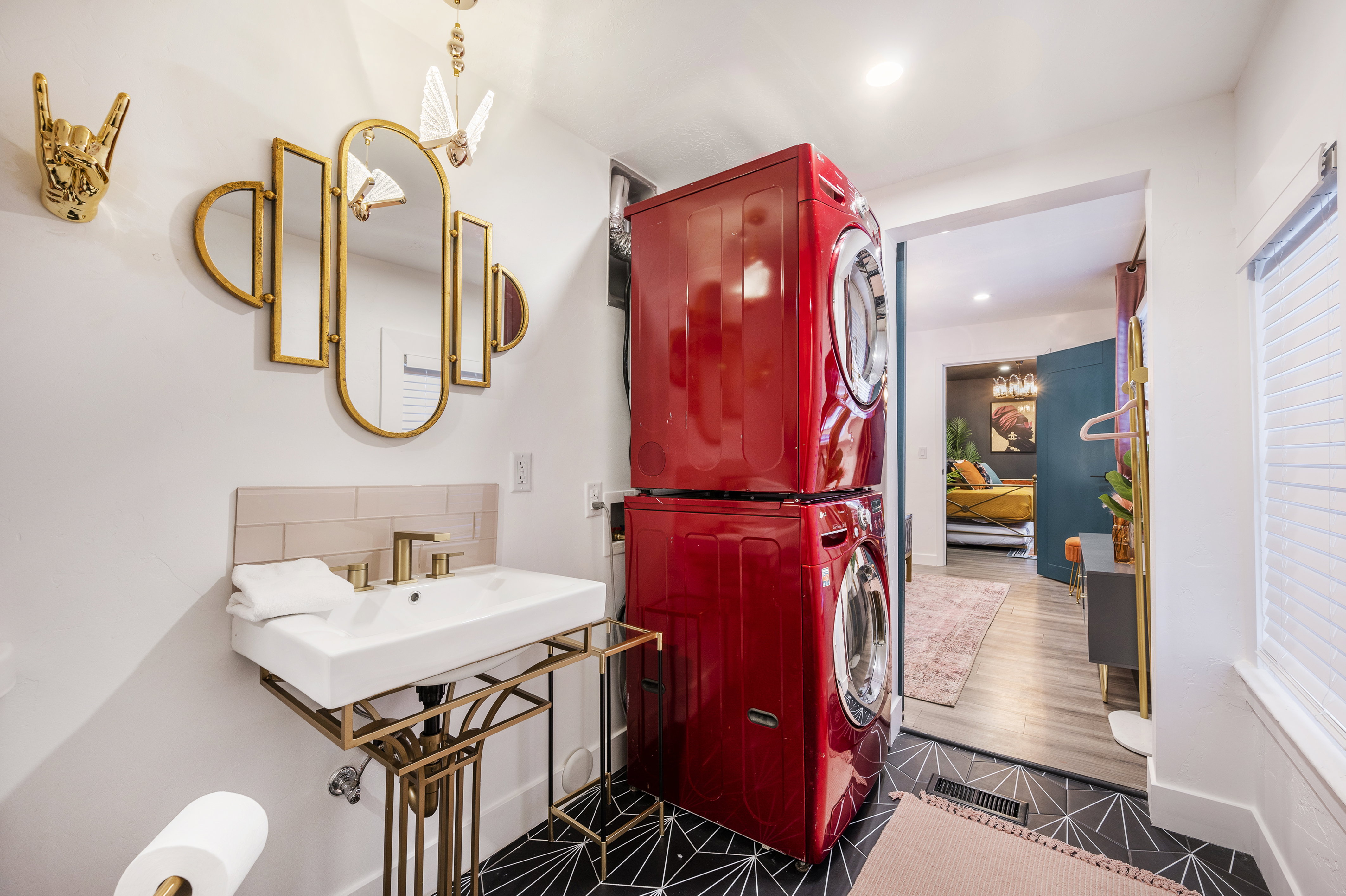 Ensuite bathroom with stacked washer and clothes dryer, recessed lighting, dark tile patterned flooring, and tasteful backsplash