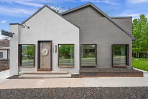 Rear view of house featuring stucco siding
