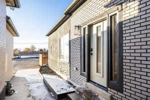 Entrance to property with brick siding