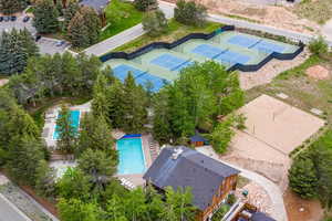 Aerial view of clubhouse, volleyball courts, two pools and tennis/pickleball courts