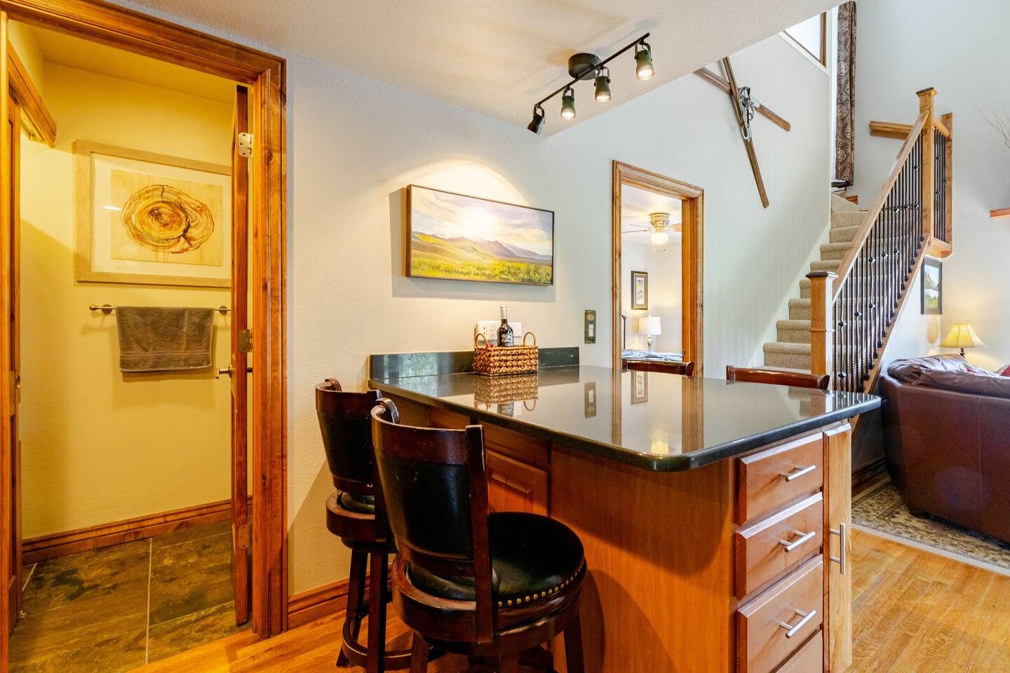 Large island with storage. View into 1/2 bath and laundry