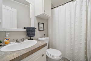 Bathroom with a shower with curtain, a textured ceiling, and vanity