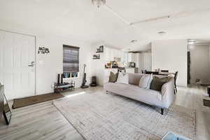 Living room with light wood-style flooring