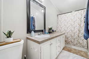 Full bathroom featuring vanity, a shower with shower curtain, and a textured ceiling